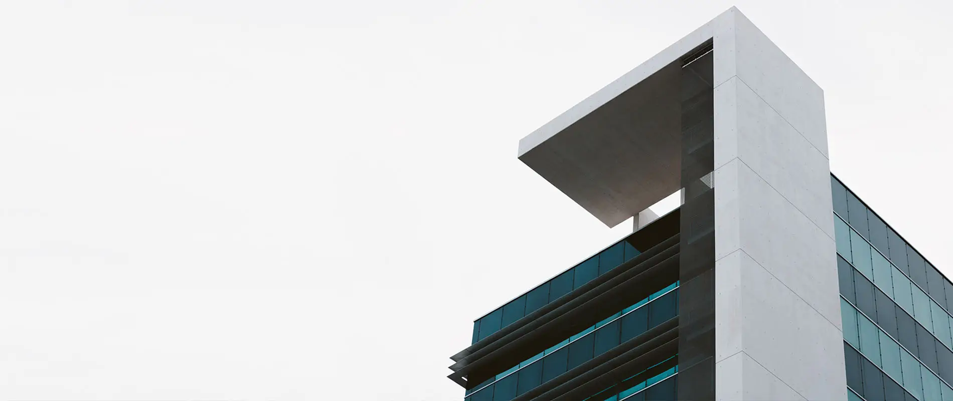 Corner of a commercial building against the sky